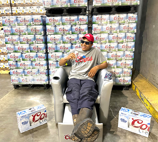 Man sitting in Coors light chair